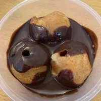 Profiteroles with custard and chocolate sauce refrigerated